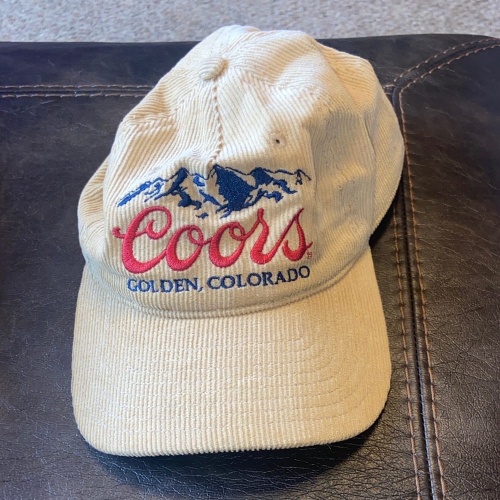 Coors Courdoroy tan adjustable baseball cap with red and navy blue embroidery.